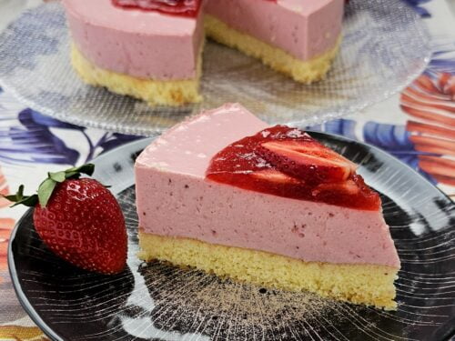 Strawberry Bavarois topped with fresh strawberries and a drizzle of berry sauce.