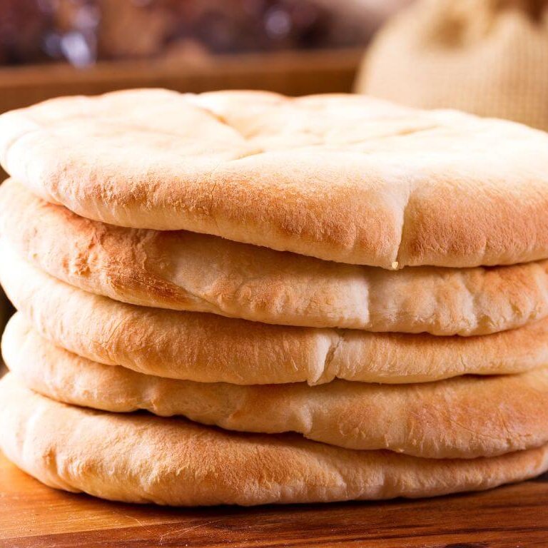 Gluten-Free Pita Bread on a Wooden Board with Hummus Dip